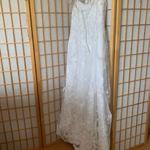 Intricate lace beaded wedding gown with train